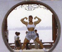 Woman bodybuilder posing in a doorway.